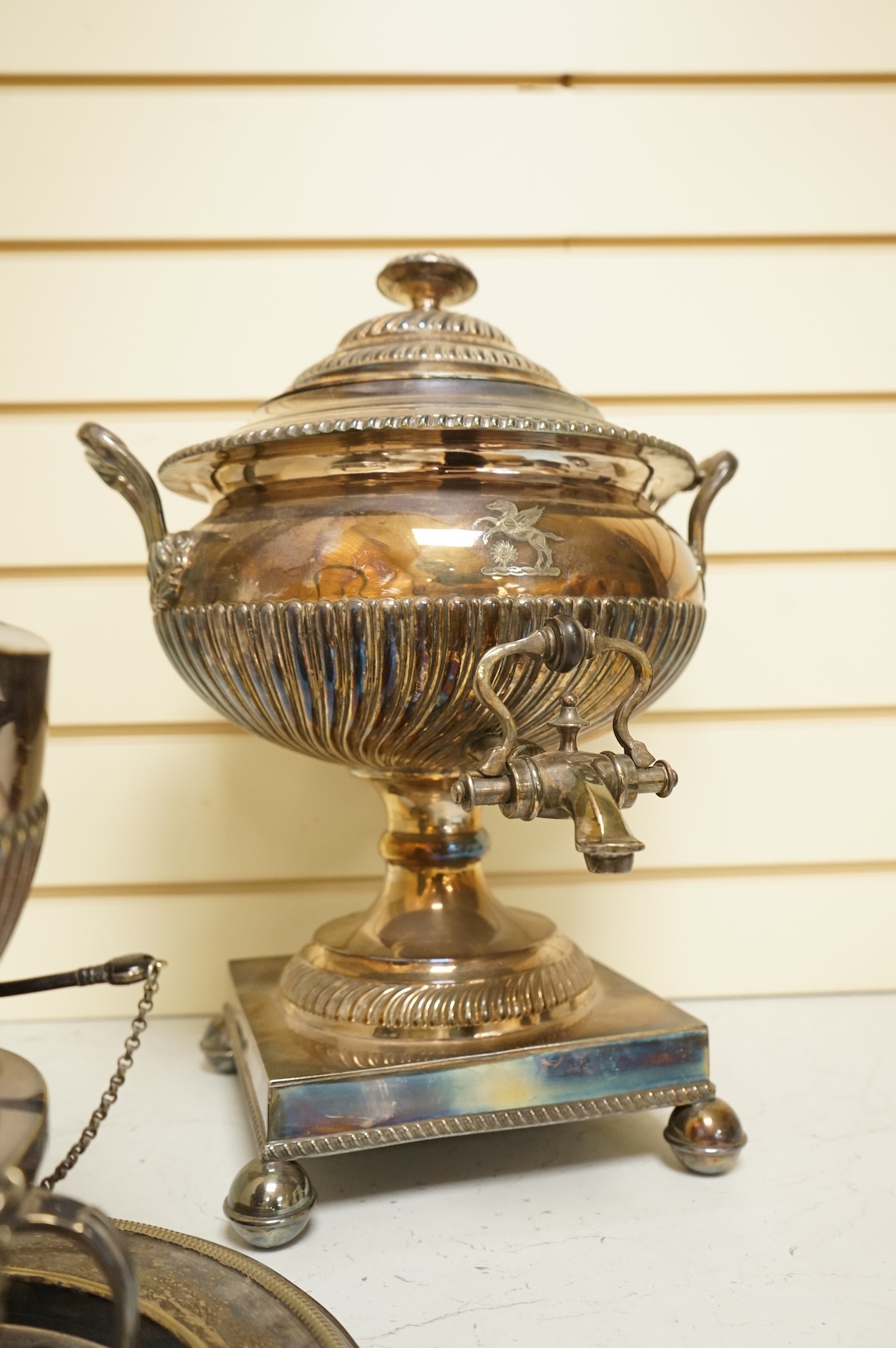 A Victorian silver plated urn, height 42cm, a silver plated spirit kettle and two circular dishes.